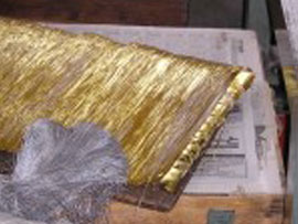 The completed gilded paper is cut into long thin strips