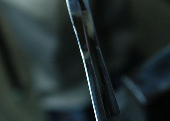 A piece of gold leaf is spread over the paper and pressed carefully by hand